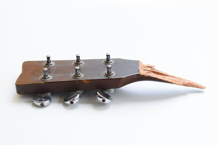 part of broken wood acoustic guitar isolated on white background