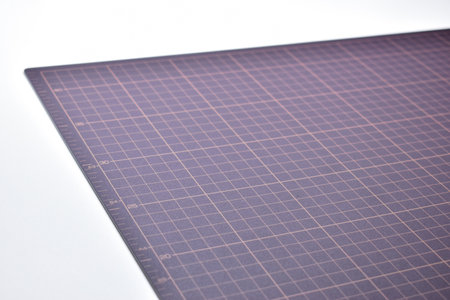 black cutting mat board on white background with line and scale measure guide pattern for object art design, tool equipment of diy craft workの写真素材