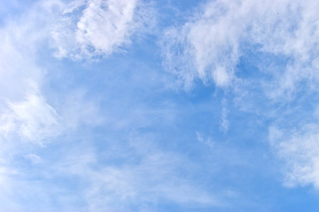beautiful blue sky and white fluffy group of clouds with sunrise in the morning, natural backgroundの写真素材