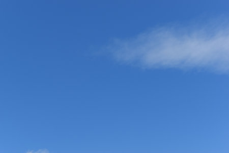 beautiful blue sky and white fluffy group of clouds with sunrise in the morning, natural backgroundの写真素材