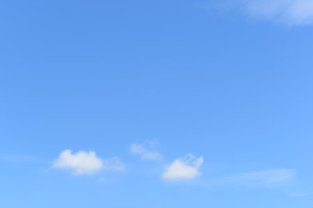 beautiful blue sky and white fluffy group of clouds with sunrise in the morning, natural backgroundの写真素材