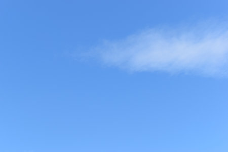 beautiful blue sky and white fluffy group of clouds with sunrise in the morning, natural backgroundの写真素材