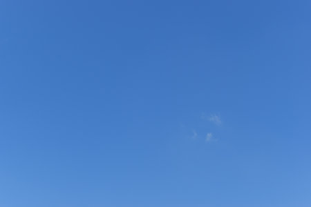 beautiful blue sky and white fluffy group of clouds with sunrise in the morning, natural backgroundの写真素材