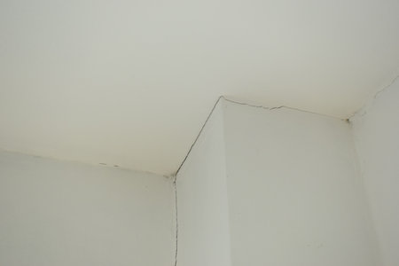 crack on white wall from earthquake, construction industryの写真素材