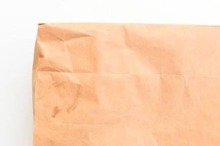 crease brown paper texture on white background, recycle materialの写真素材