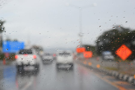car on highway road with rainny season, blurred image