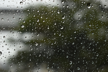 water drop on mirror in rainy day, blur natural backgroundの写真素材