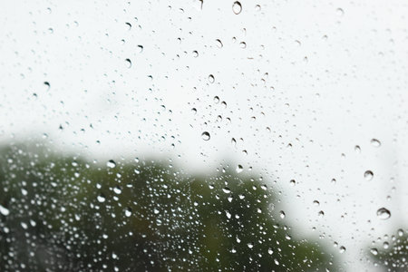 water drop on mirror in rainy day, blur natural backgroundの写真素材