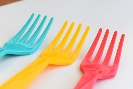 colorful fork isolated on white background, plastic cutlery for picnicの写真素材
