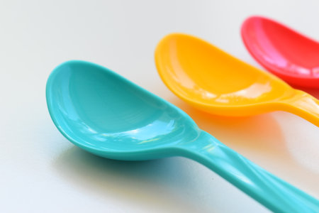colorful spoon isolated on white background, plastic cutlery for picnic