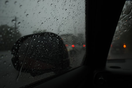 car on highway road in the night with heavy rain season, blurred image