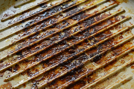 dirty white circle pan after cooking in homeの写真素材