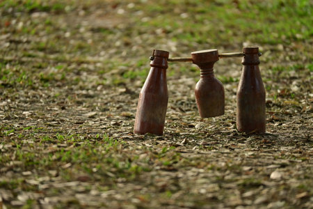 wooden bottle for petanque sport Thai style, equipment on green grass