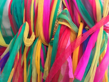 Colorful stripe cloth on Buddha statue in the temple