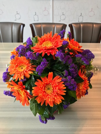 Orange gerbera flower decoration on dining tableの素材