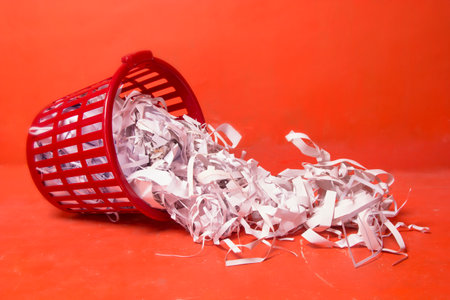 waste white paper or waste documents on an orange background, selective focusの写真素材