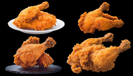 closeup, set of fried cripsy chicken isolated on black backgroundの素材