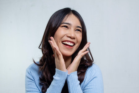Beautiful Asian woman long hair looks happy, woman head cropped negative space, isolated on whiteの写真素材