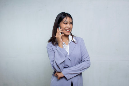Asian business woman using smartphone in navy blue shirt suit white background, office woman advertisingの写真素材