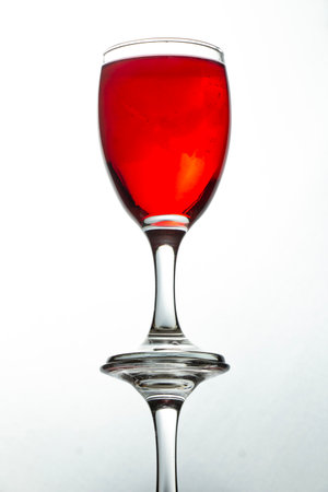bottom view photo of reflective red liquid glass on white background.の写真素材