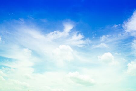 white fluffy clouds in the blue skyの写真素材