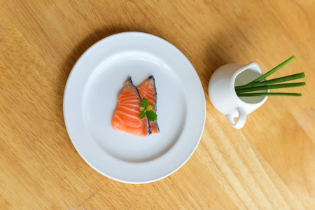 salmon in white dish on woodenの写真素材