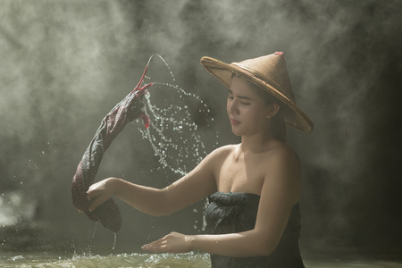 Asia,Beautiful woman washing in the creek.の写真素材