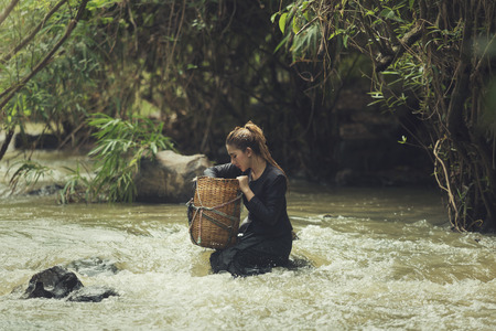 Asian,Beautiful girl posture on the creekの写真素材