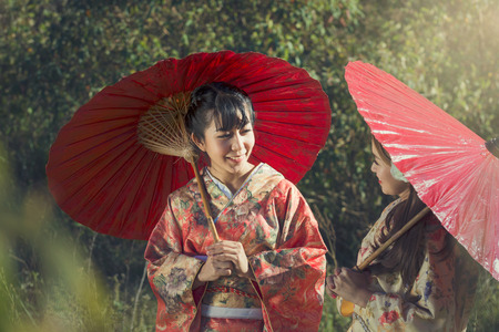 Asia, Girls in kimonos acting smile.の写真素材