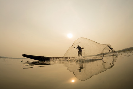 Asian, Fisherman action on the boat fishingnet.の写真素材