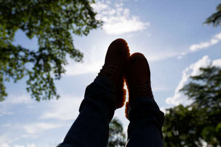 Men's shoes sitting on a swing Life is a journeyの写真素材