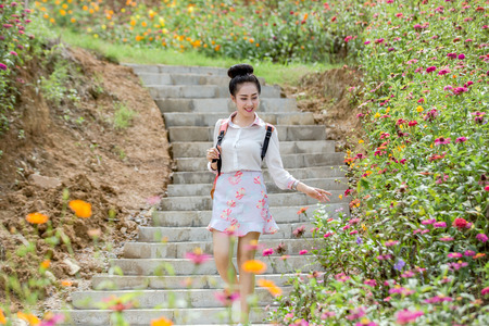 Young cute woman with flower gardenの写真素材