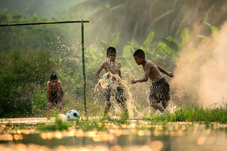 Soccer players in action on the riverの写真素材