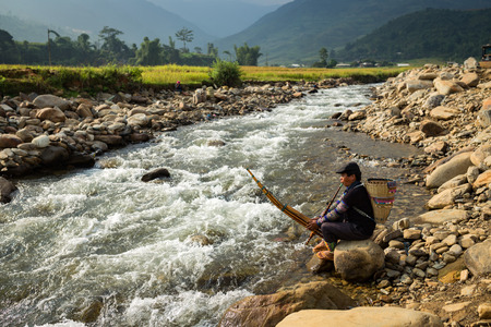 Vietnamese old man Hmong musical instruments are blow local riverside at vietnam.のeditorial素材