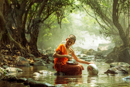 Novice monks were washed in a stream の写真素材
