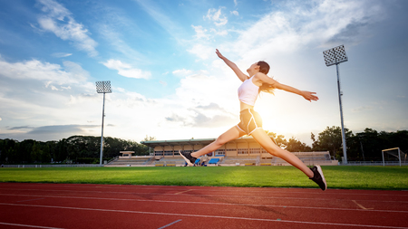 Motion Asian young woman exercises with running and jumping. In the treadmill or running track.の写真素材