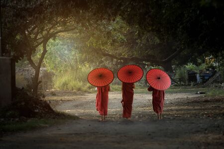 Three novice monk walking together go to temple in Bagan Mandalay Myanmar.の写真素材