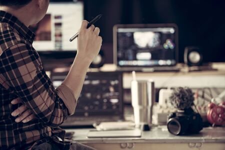 Editor content creator in house studio working use laptop and PC create content online or this lifestyle of Vlog freelance.の写真素材
