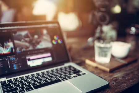 Close up laptop video cutting and grading color footage this is a lifestyle of Vlog or Blogger freelanceの写真素材