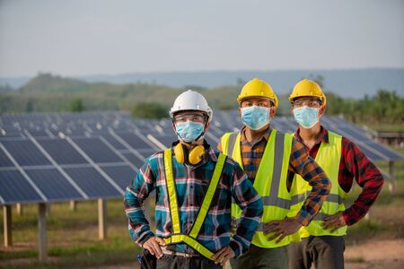 The new normal of the electrical engineering team is working in a solar panel farm or repair photovoltaicの写真素材
