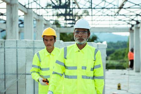 Engineering and supervisor working together in the construction site and maskedの写真素材