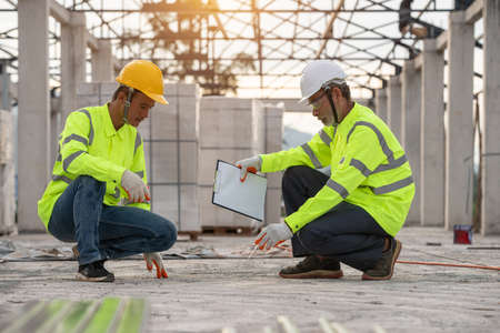 Engineering and supervisor working together in the construction site and maskedの写真素材
