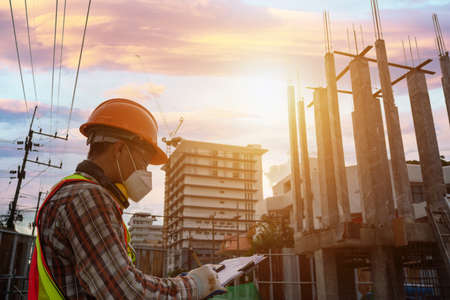 Engineer working at the construction site wearing mask
