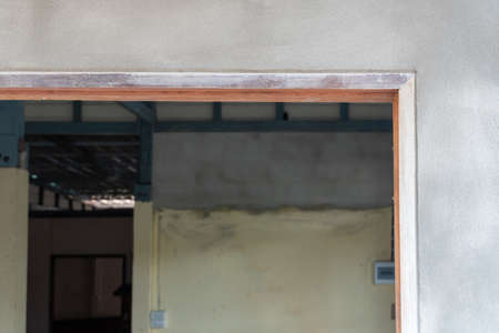The door frame in the construction of a wooden house and cement.