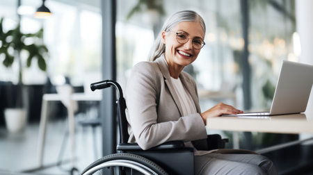 Businesswoman on the wheelchair with group friends in the modern white office in Americaの素材
