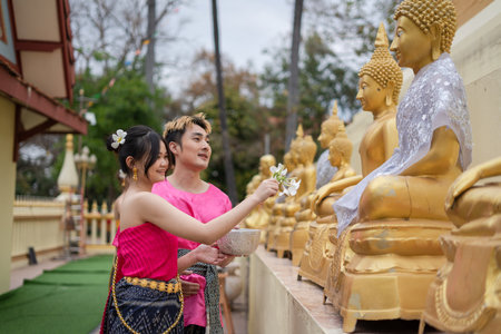 Songkran Day, young Thai people wear Thai costumes to bathe Buddha statues and play on Songkran Day.の写真素材