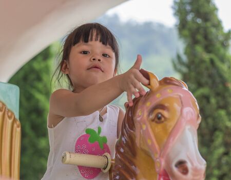 Children girl asia sitting roundaboutの写真素材