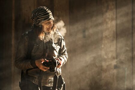 photographer women travel with black digital camera. she breathe smoke out because cold weather. she...