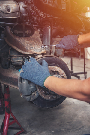 Hands of car mechanic in auto repair service.の写真素材