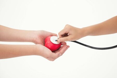 Doctor hands with stethoscope and  heart on hand patient isolated on white background. healthy and...
